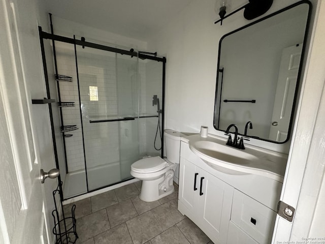 bathroom featuring toilet, tile patterned floors, a shower stall, and vanity