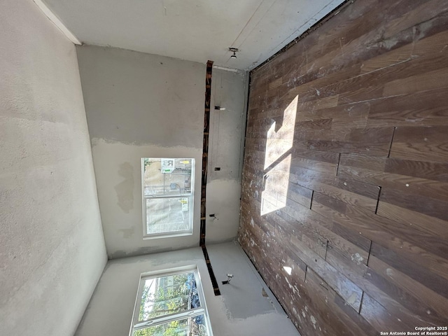 doorway to outside featuring wooden walls