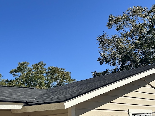 exterior details with roof with shingles