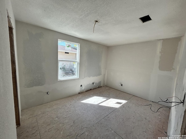 empty room featuring a textured ceiling