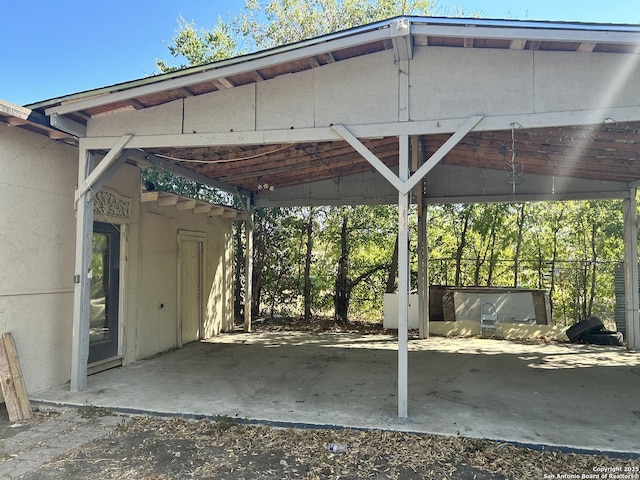 view of vehicle parking featuring an attached carport