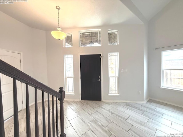 entryway featuring stairs and baseboards