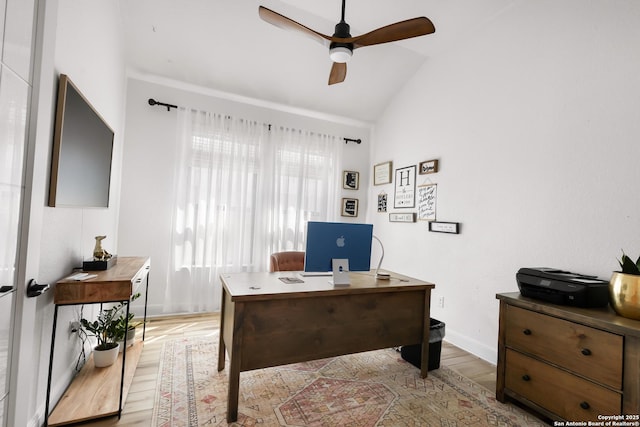 office space with light wood-style floors, vaulted ceiling, baseboards, and ceiling fan