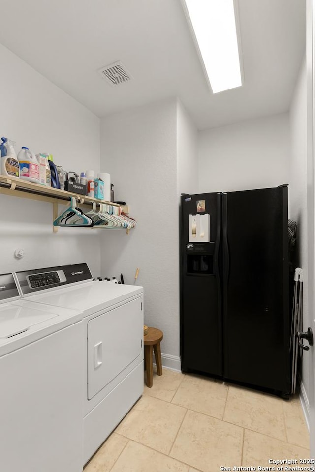 laundry area featuring visible vents, light tile patterned flooring, washer and dryer, laundry area, and baseboards