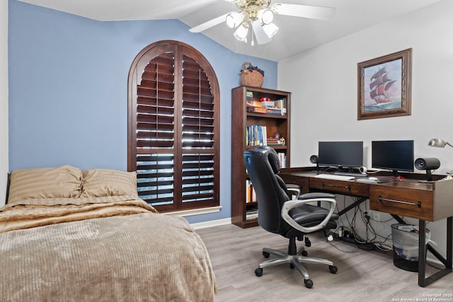 bedroom featuring baseboards, arched walkways, a ceiling fan, wood finished floors, and vaulted ceiling