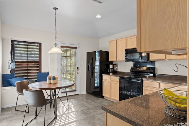 kitchen with dark countertops, black appliances, light brown cabinets, and lofted ceiling