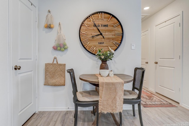 dining room with baseboards, recessed lighting, and light wood-style floors