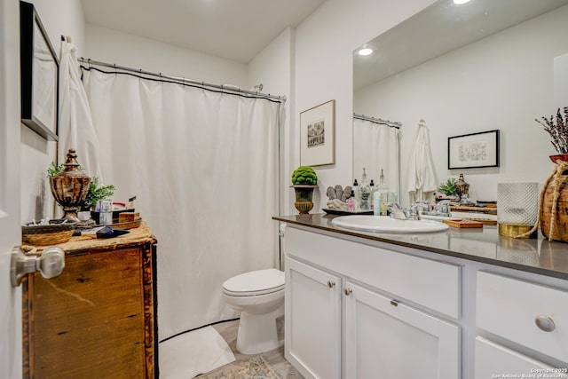 full bathroom with toilet and vanity