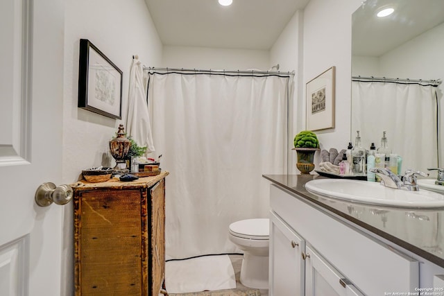 bathroom featuring toilet and vanity