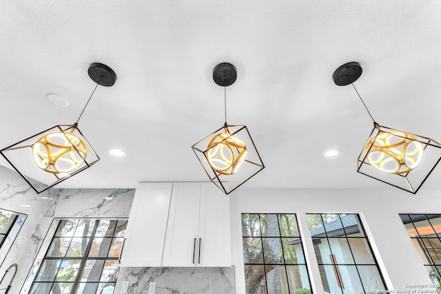 details featuring pendant lighting, recessed lighting, and white cabinets