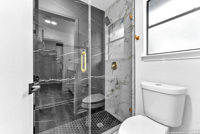 full bath with toilet and a marble finish shower