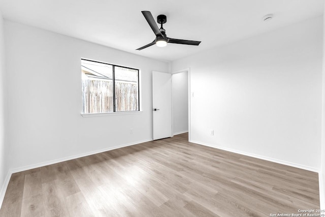 unfurnished bedroom with ceiling fan, baseboards, and wood finished floors