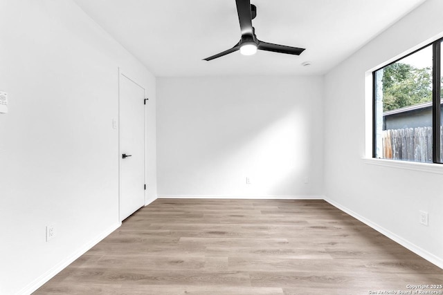 unfurnished room with baseboards, a ceiling fan, and wood finished floors