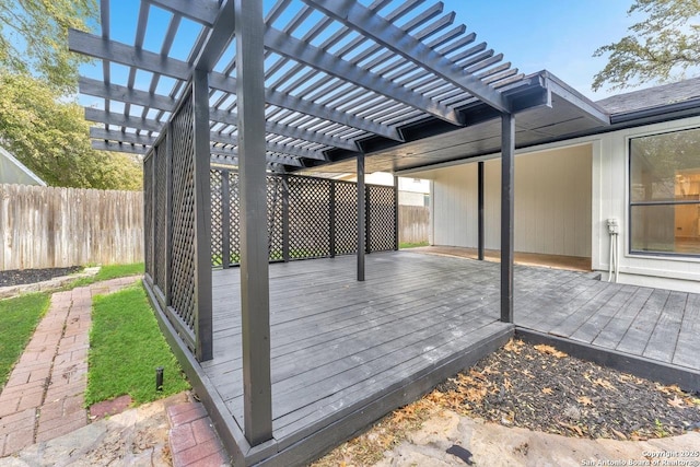 wooden terrace with a fenced backyard and a pergola