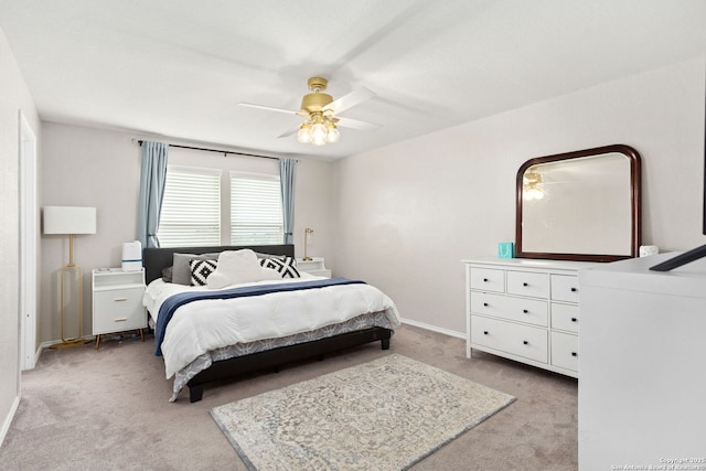 bedroom featuring light carpet, ceiling fan, and baseboards