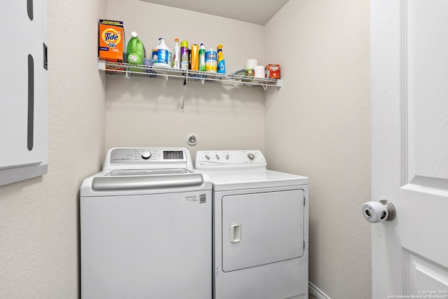 washroom featuring laundry area and washer and clothes dryer