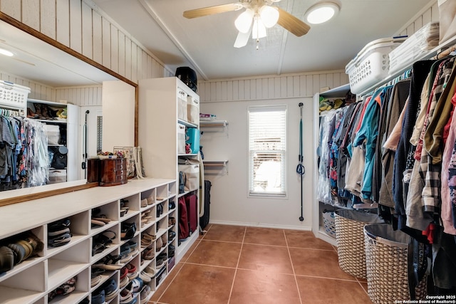 walk in closet with tile patterned flooring and ceiling fan