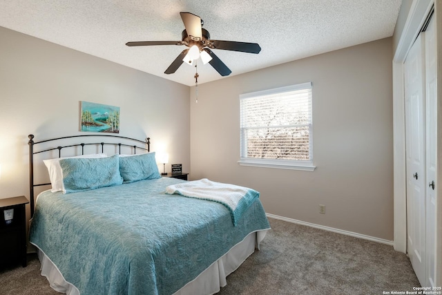 bedroom with carpet floors, a textured ceiling, baseboards, and a closet