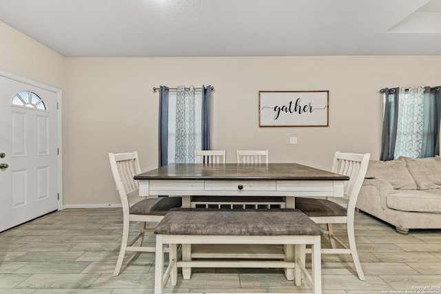 dining room with baseboards and wood finish floors