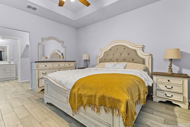 bedroom with visible vents, ensuite bathroom, wood tiled floor, ceiling fan, and baseboards