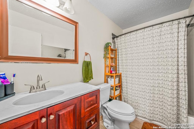 full bath featuring toilet, tile patterned floors, a textured ceiling, and vanity