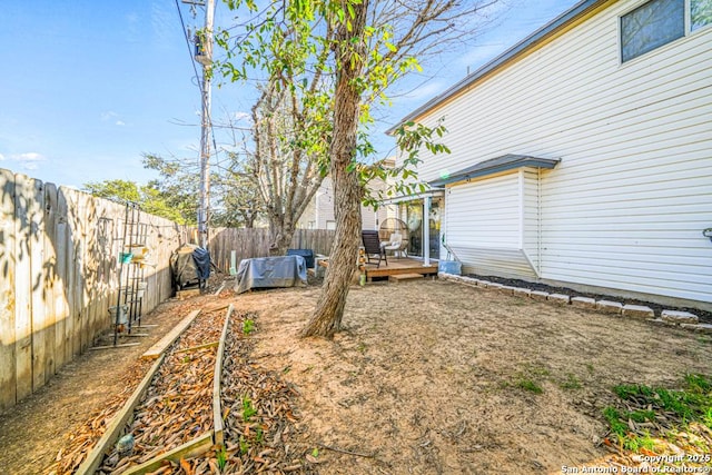 view of yard with a fenced backyard and a wooden deck