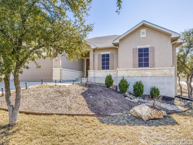 ranch-style house featuring stone siding, an attached garage, and stucco siding