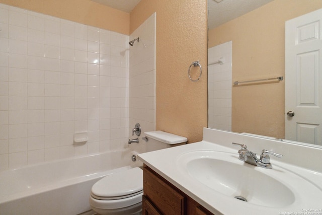 full bath featuring washtub / shower combination, a textured wall, vanity, and toilet