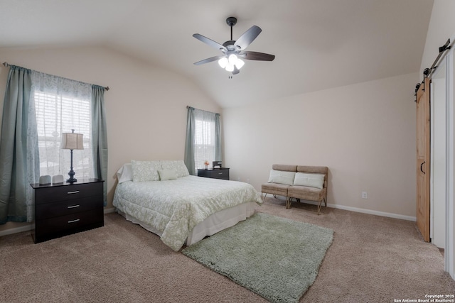 bedroom with a barn door, carpet floors, a ceiling fan, baseboards, and vaulted ceiling