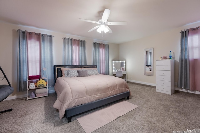 bedroom featuring carpet, ceiling fan, multiple windows, and baseboards