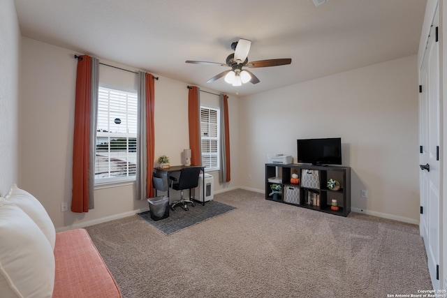 office featuring carpet floors, ceiling fan, and baseboards