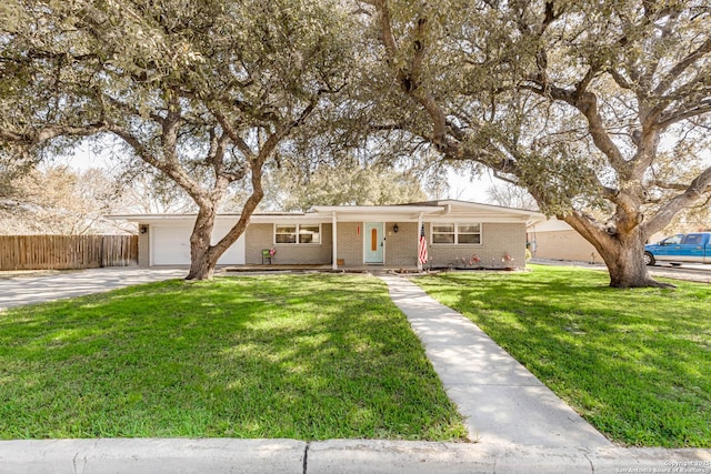 ranch-style home featuring a garage, concrete driveway, fence, a front lawn, and brick siding