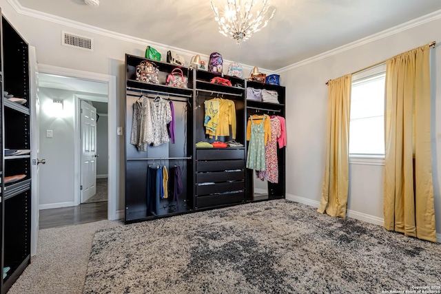 carpeted bedroom featuring visible vents, crown molding, a notable chandelier, and baseboards