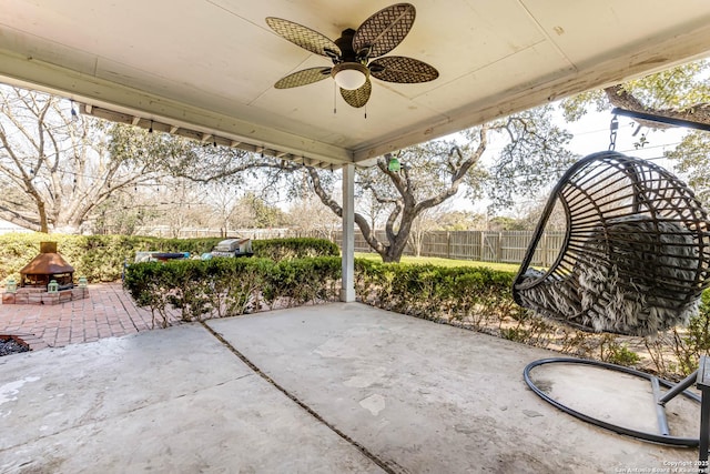 view of patio with a fire pit, ceiling fan, and fence