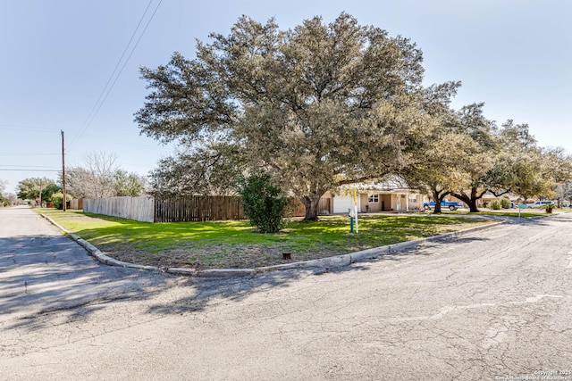 view of front of house with a front lawn and fence