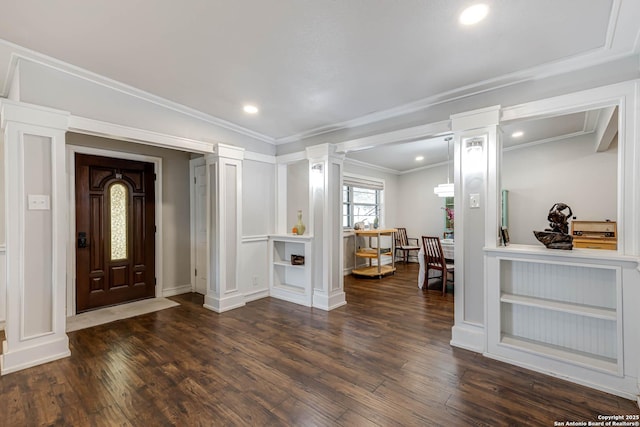 entryway featuring recessed lighting, wood finished floors, baseboards, ornamental molding, and decorative columns