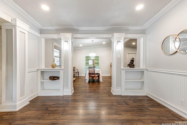 interior space featuring decorative columns, dark wood finished floors, and crown molding