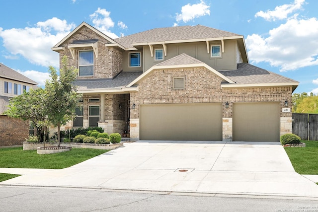 view of front facade featuring an attached garage, a shingled roof, concrete driveway, and brick siding