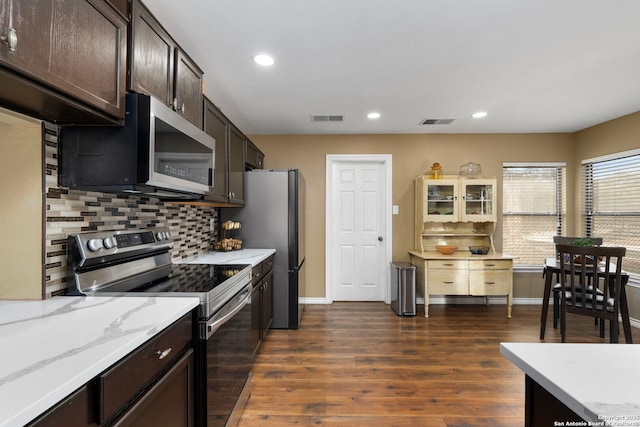 kitchen with dark wood-style floors, visible vents, appliances with stainless steel finishes, and tasteful backsplash