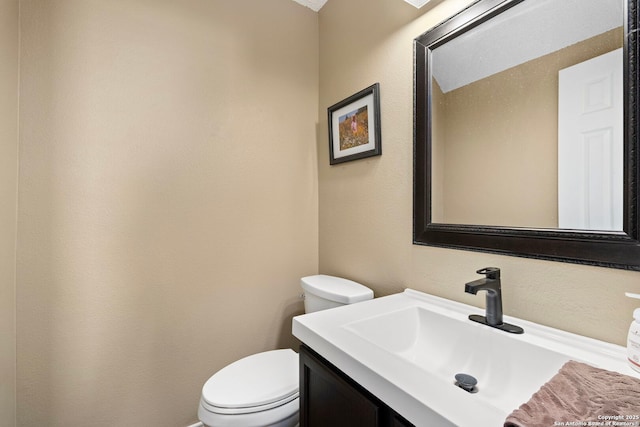 bathroom with toilet and vanity