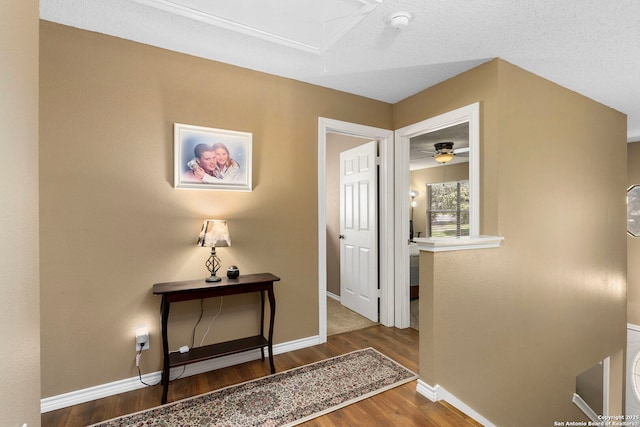 hall featuring wood finished floors and baseboards