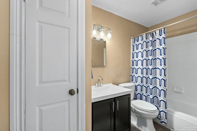 bathroom featuring a textured ceiling, toilet, visible vents, vanity, and shower / tub combo with curtain