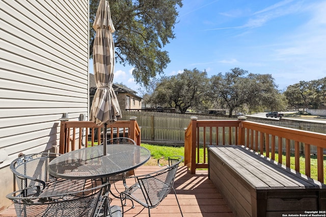 wooden deck featuring outdoor dining area and fence