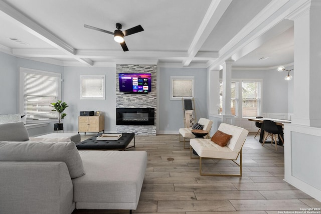 living room featuring beam ceiling, visible vents, wood tiled floor, a large fireplace, and coffered ceiling