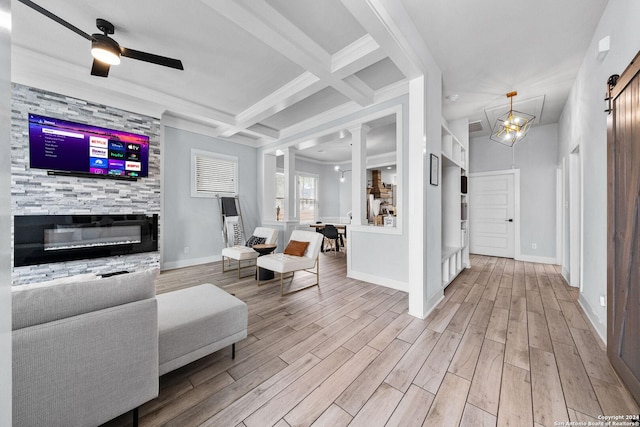 living room with a stone fireplace, coffered ceiling, wood finished floors, baseboards, and beam ceiling