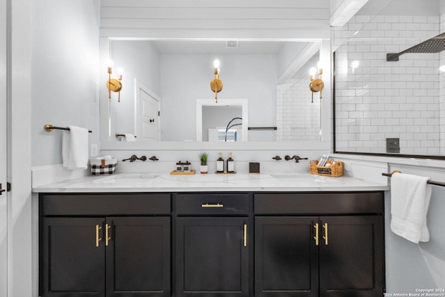 bathroom with tasteful backsplash, a sink, and double vanity