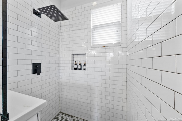 full bath featuring tiled shower