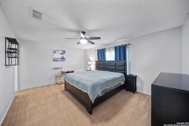 bedroom with light colored carpet, visible vents, ceiling fan, a textured ceiling, and baseboards