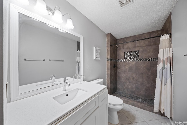 bathroom featuring visible vents, tiled shower, toilet, tile patterned flooring, and a textured ceiling