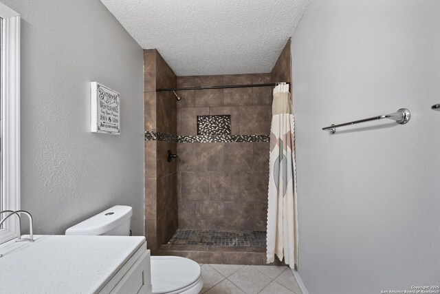 full bath featuring tiled shower, toilet, tile patterned flooring, a textured ceiling, and vanity